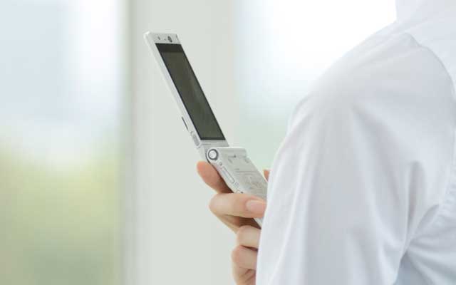 携帯電話で予約をしているイメージ